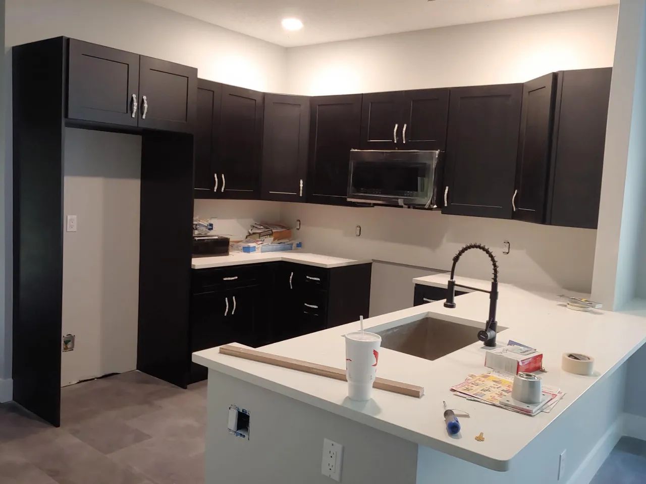 Espresso shaker kitchen cabinets with white countertops