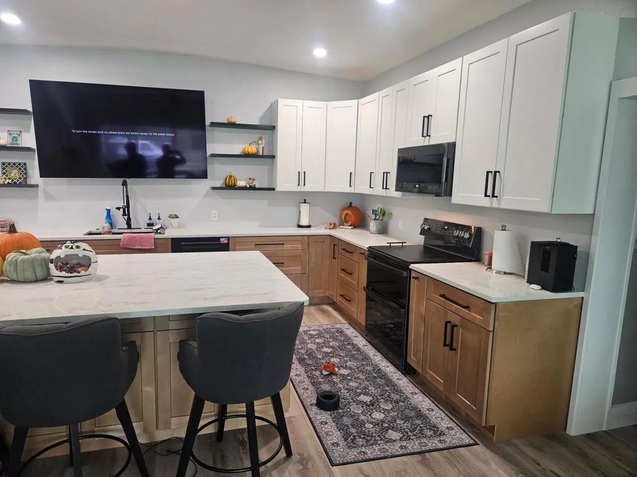 L-shaped kitchen with island and black hardware