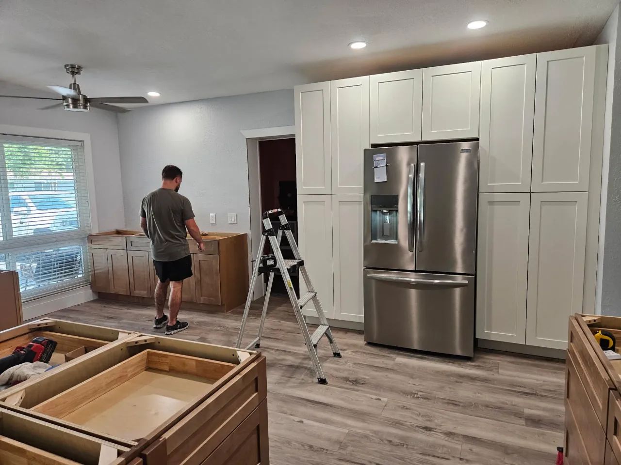 Tall pantry cabinets installed beside the refrigerator