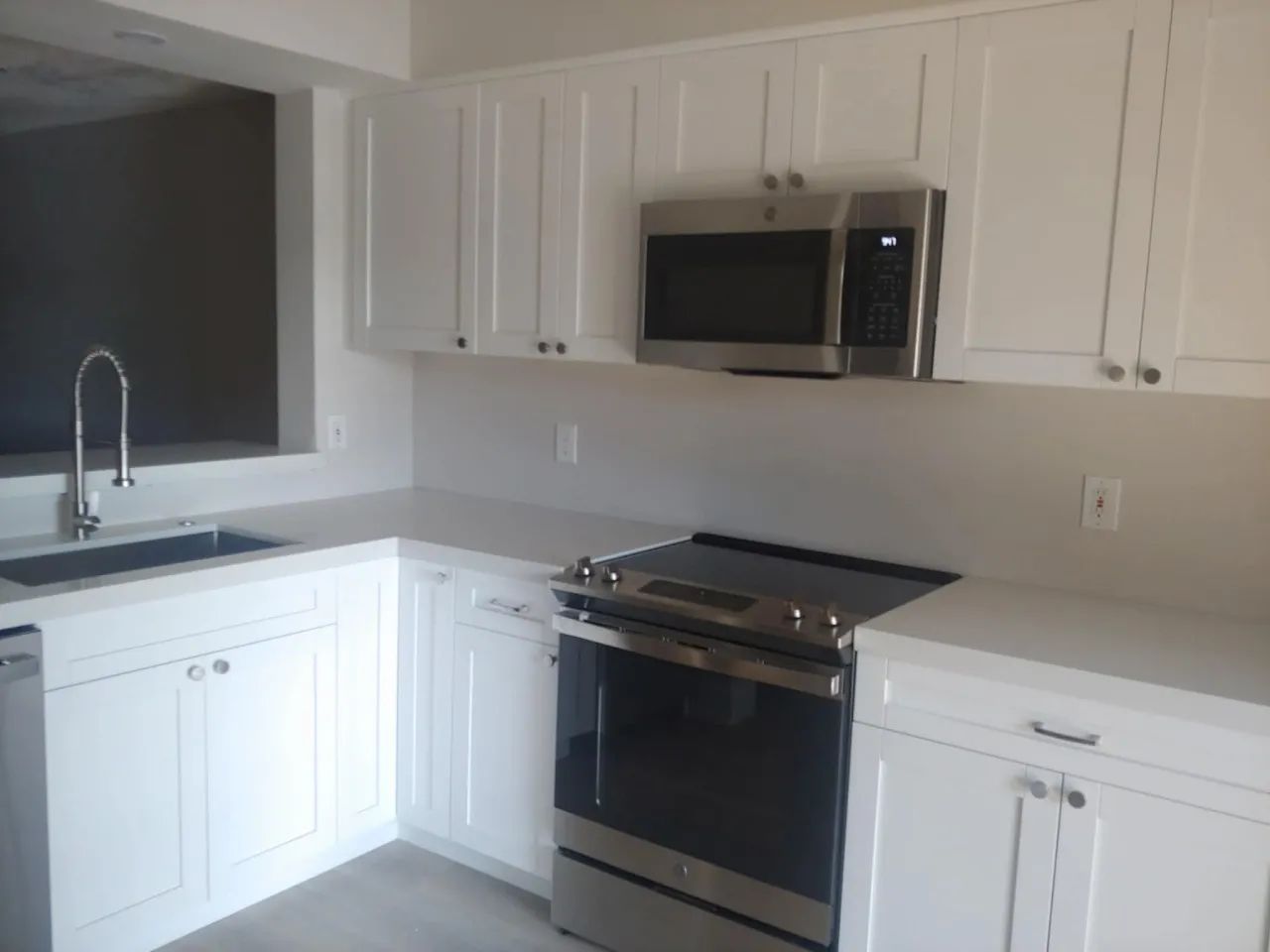 White shaker kitchen with stainless appliances